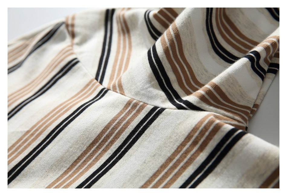 Close-up of the cream shirt's black and brown stripes across draped fabric.