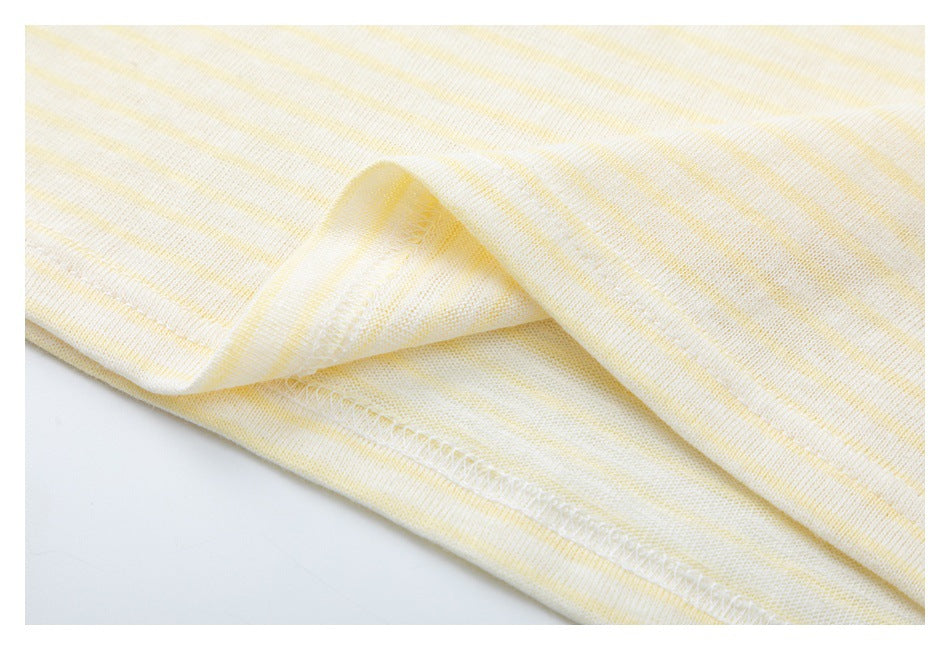 Close-up of the folded hem and stitching on a cream top with pale yellow stripes.
