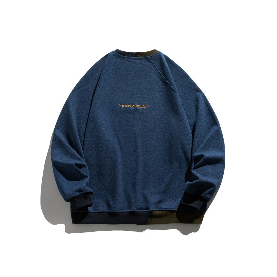Back view of a navy raglan crewneck sweatshirt with dark ribbed cuffs and hem and small gold embroidery.