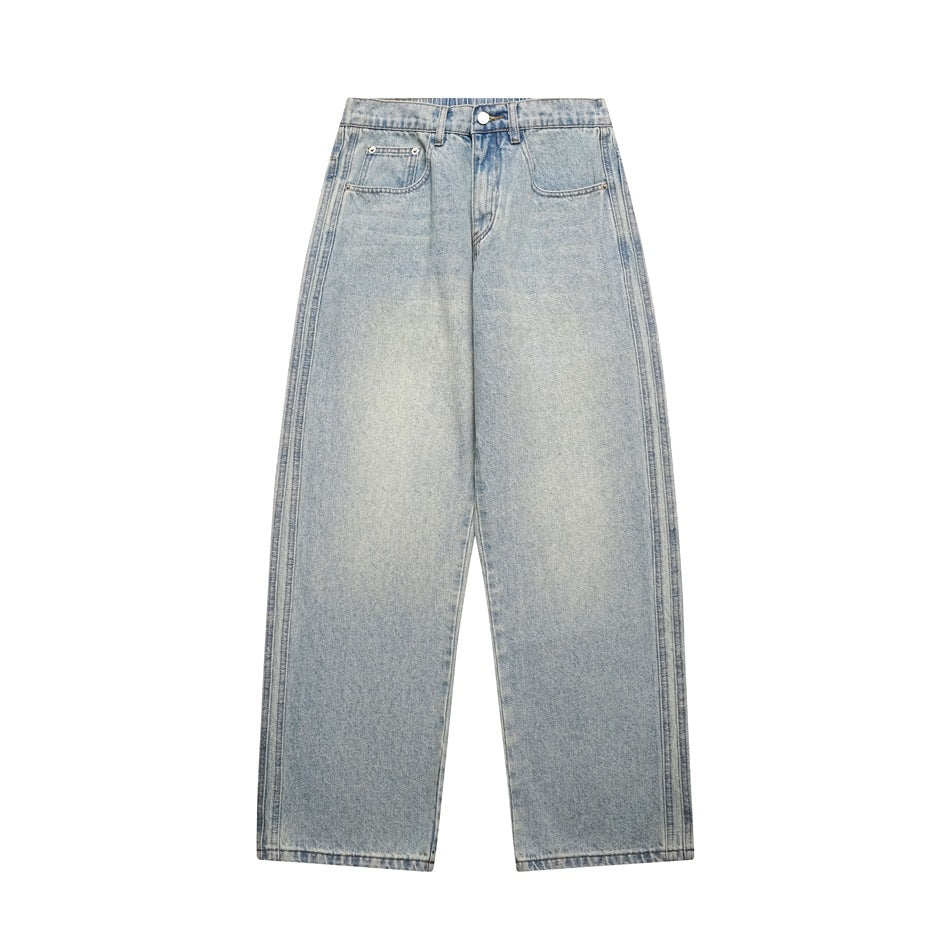 Flat-lay front of men's wide straight-leg jeans in light vintage blue faded wash with side seam detailing