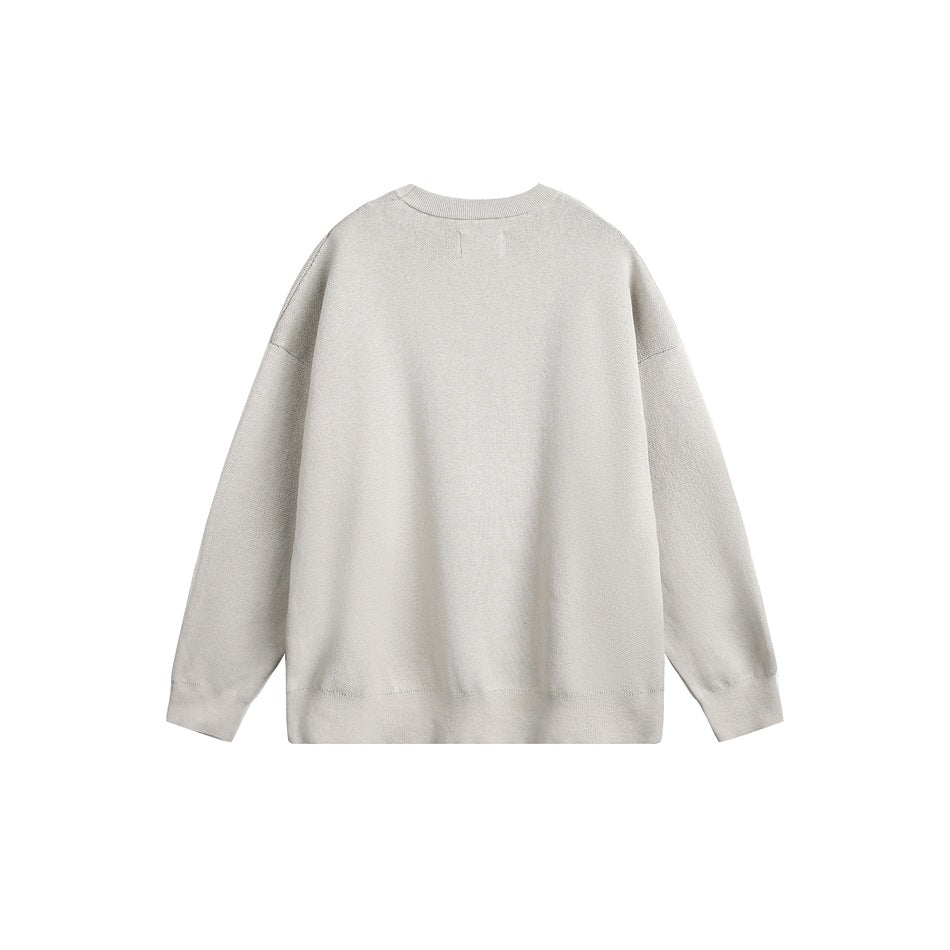 Back view of a plain light gray crewneck sweater with long sleeves and ribbed cuffs and hem.
