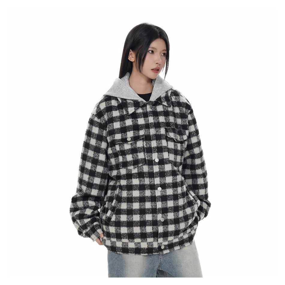 Model wearing black and white check jacket with gray hood layer and snap front, with light-wash jeans
