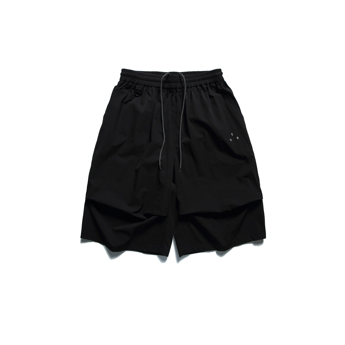 Black knee-length shorts with drawstring waist, D-ring, side pockets, pleated front and small printed letters, flat lay