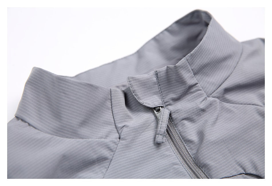 Close-up of the gray vest's stand collar, zipper pull, and fine striped fabric texture.
