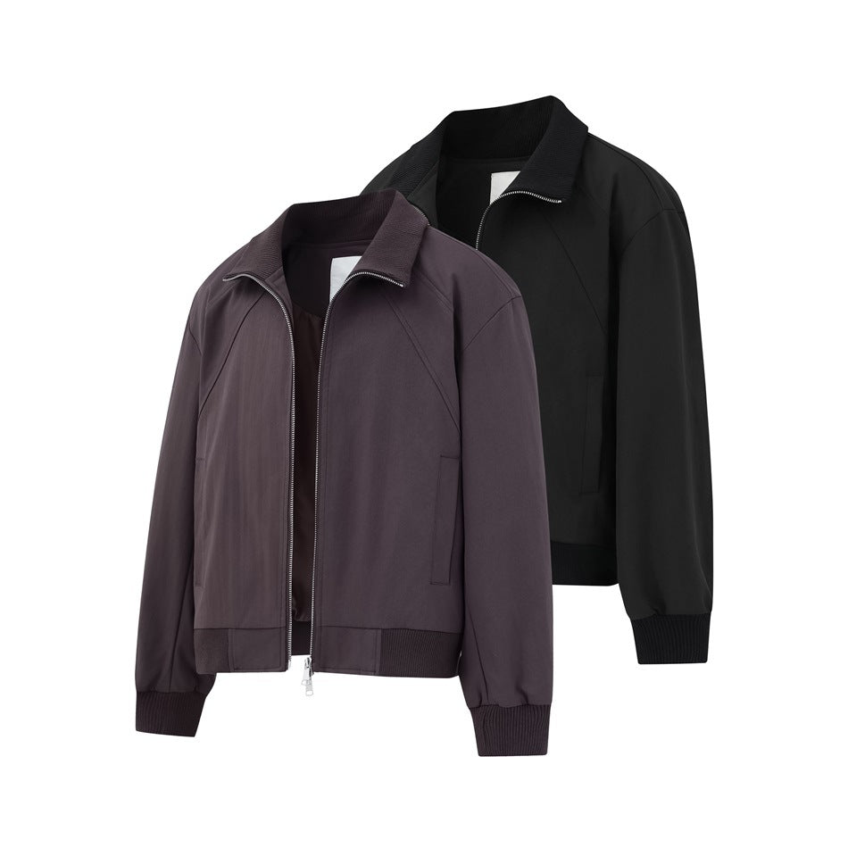 Two zip-front jackets shown together: one dark charcoal and one black, both with ribbed collars, cuffs, and hems.