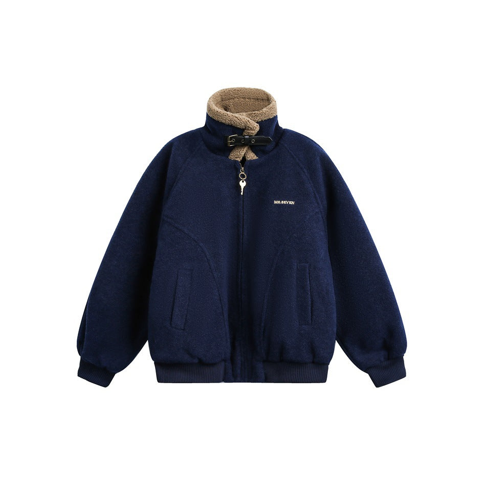 Navy blue zip jacket with tan fleece-like stand collar, black buckle strap, key zipper pull and ribbed trim