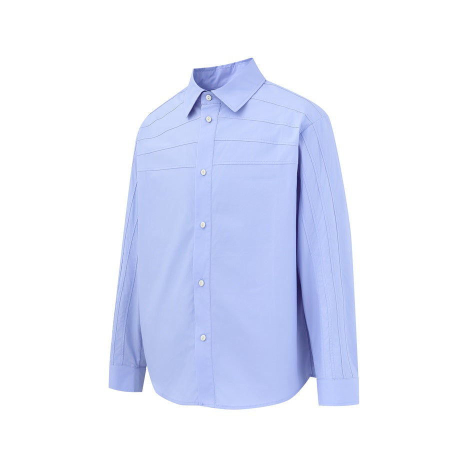 Front view of a light blue long-sleeve button-up shirt with a pointed collar and horizontal stitched panels.