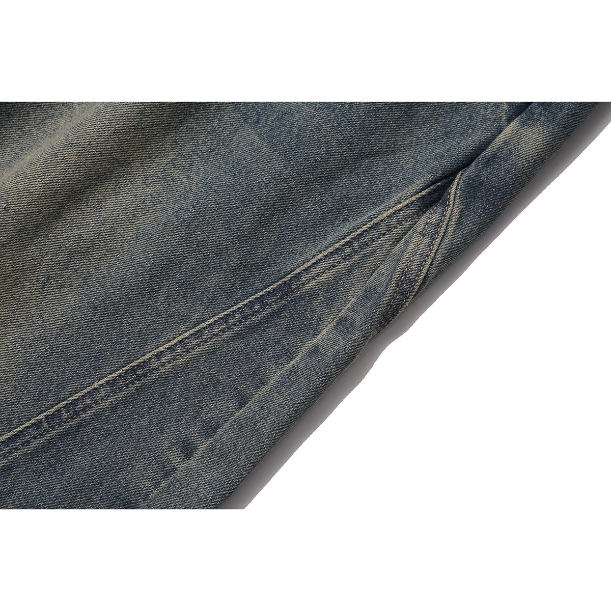Close-up of faded dark blue denim and a stitched seam on the jeans.