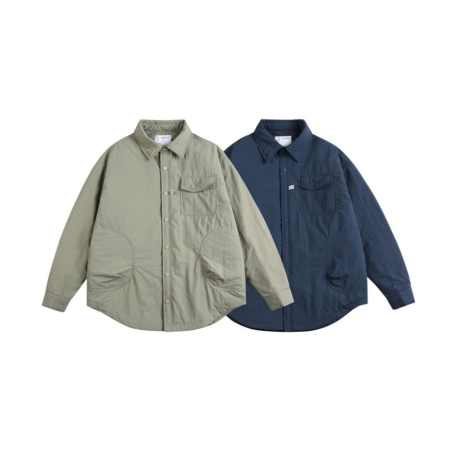 Two jackets displayed front-on: one light sage and one navy, each with a collar, snap front, chest flap pocket, and large