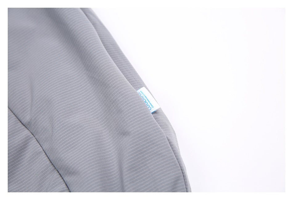 Close-up of gray pinstriped fabric with a small blue-and-white sewn label.