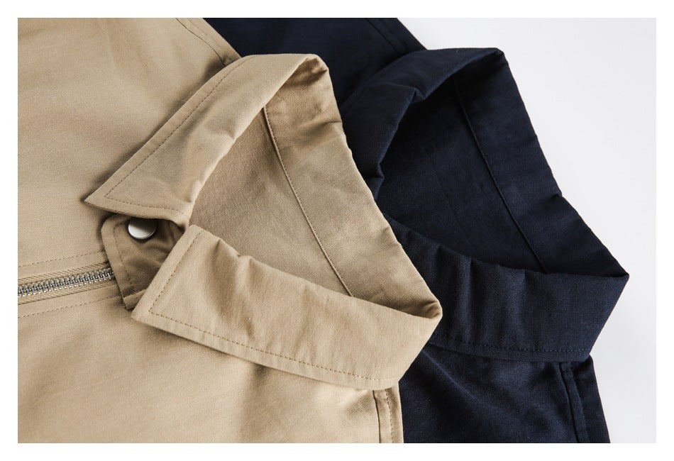 Close-up of tan and dark navy jackets showing their collars, zipper, and snap fastening.