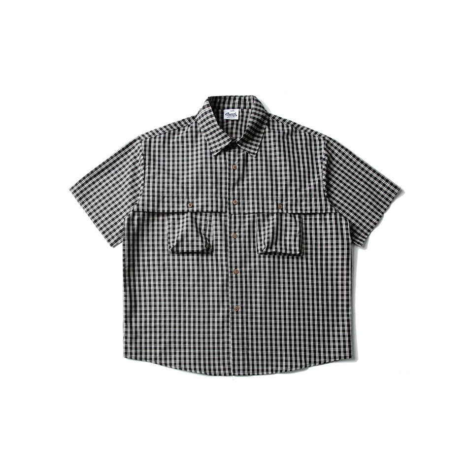 Black and white small-check short-sleeve button-up shirt with two chest flap pockets, flat lay front view