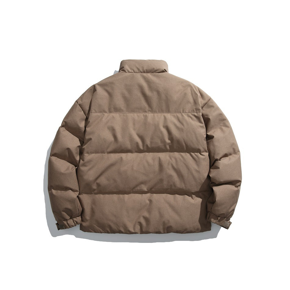 Back view of a taupe padded jacket with horizontal quilting, a stand collar and elastic cuffs.