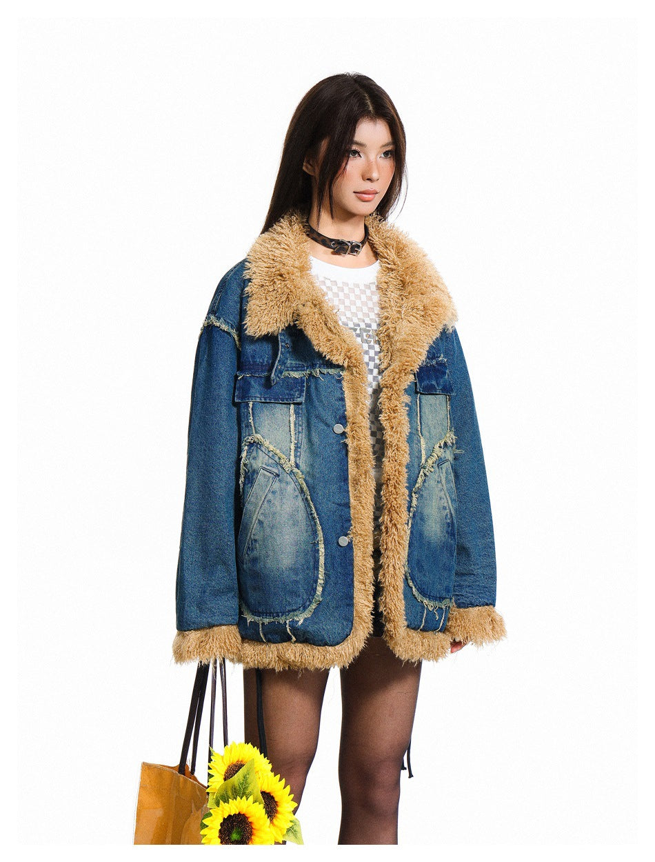 Model wearing an oversized blue denim jacket with tan shaggy trim, wide collar, and large patch pockets, front view.