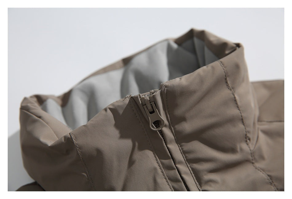 Close-up of the jacket’s high collar, gray lining, and front zipper pull.