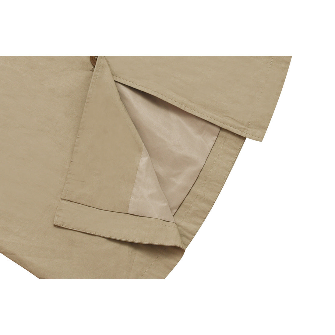 Close-up of the beige coat's inner lining, folded front, and stitched hem.