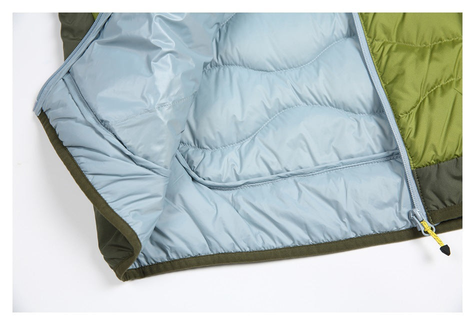 Close-up of an open jacket showing pale blue quilted lining and pocket beside olive-green outer panels.