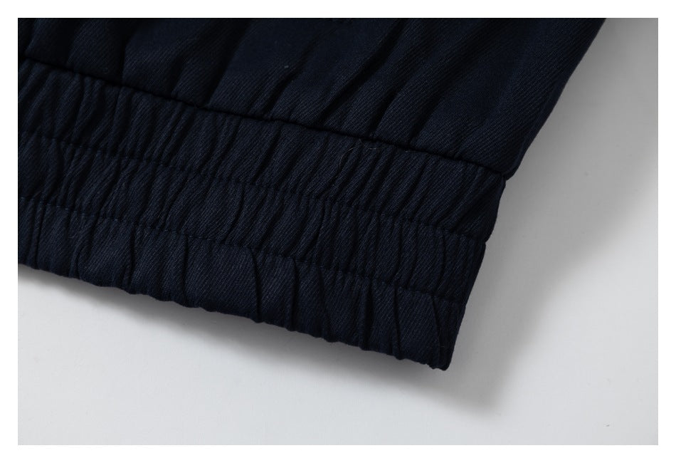 Close-up of the jacket's gathered elastic hem in navy.