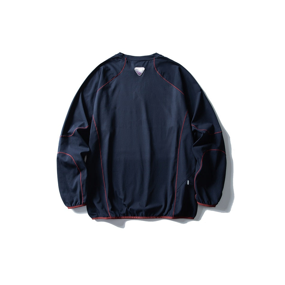 Back view of a dark navy pullover with long raglan sleeves and red contrast piping.