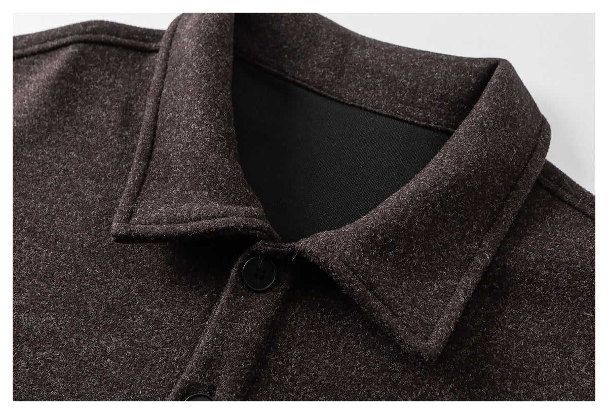 Close-up of a dark brown jacket's pointed collar, black lining, and front buttons.