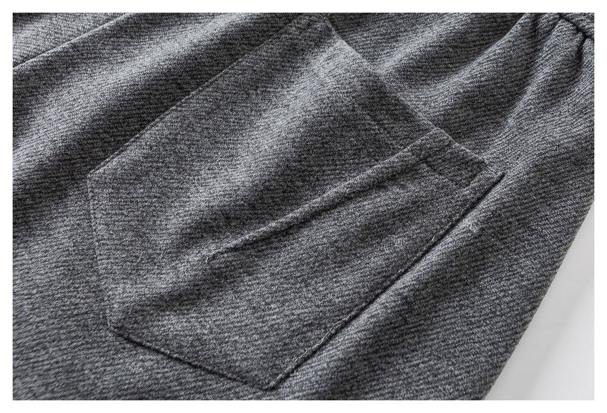 Close-up of a rectangular patch pocket on heather gray joggers.