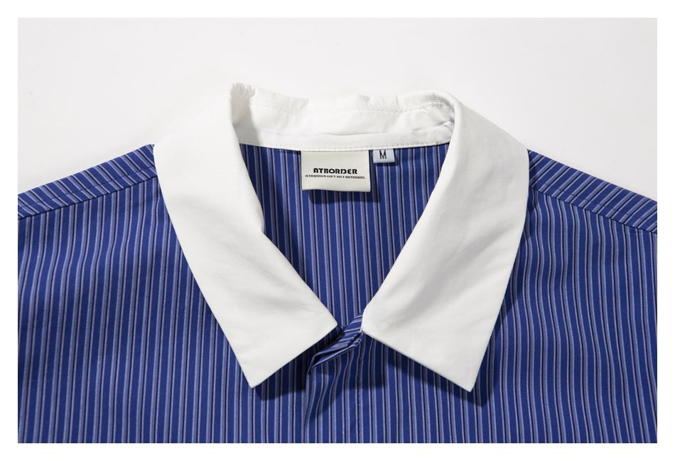 Close-up of the white collar and neck label on a blue vertically striped shirt.