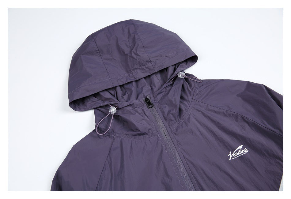 Close-up of the purple hood and upper front, showing the drawcord toggles, zipper, and small white chest logo.