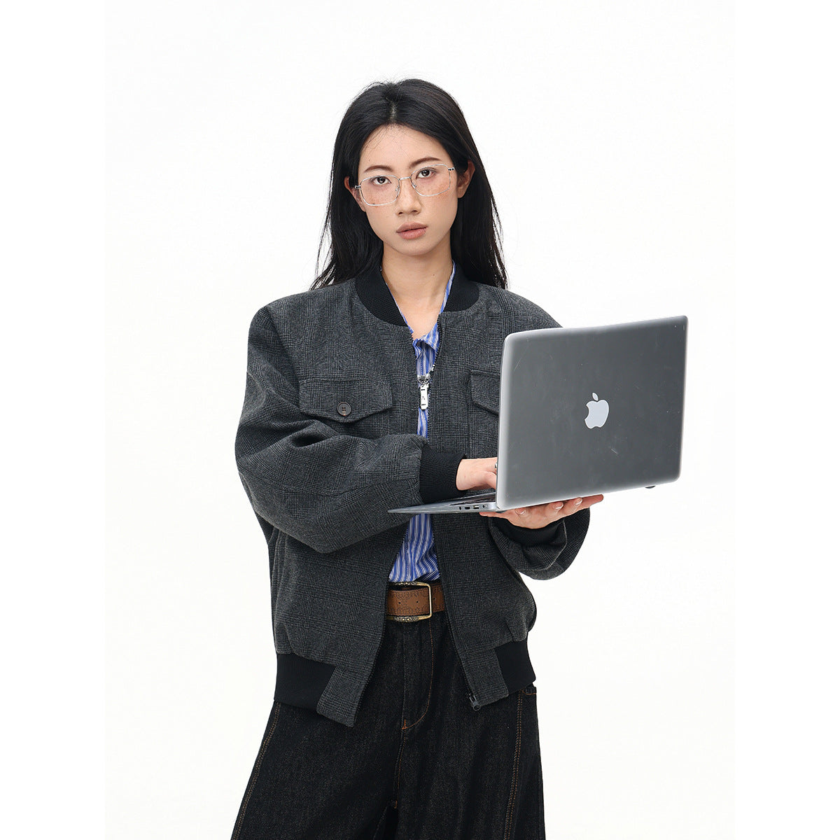 Front view of a model in a charcoal plaid bomber jacket with black ribbed trim and button-flap chest pockets.