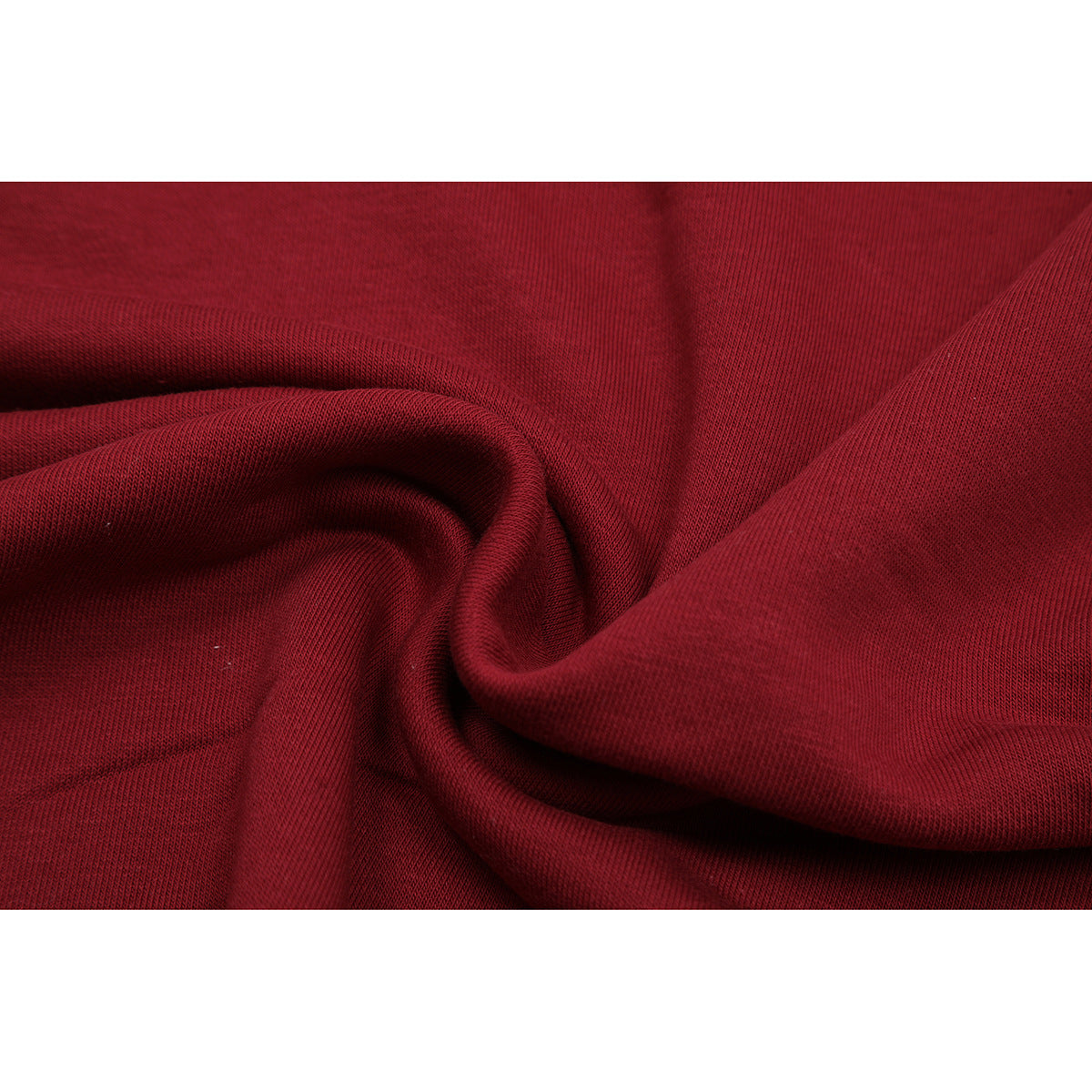 Close-up of burgundy sweatshirt fabric gathered into folds, showing its surface texture.