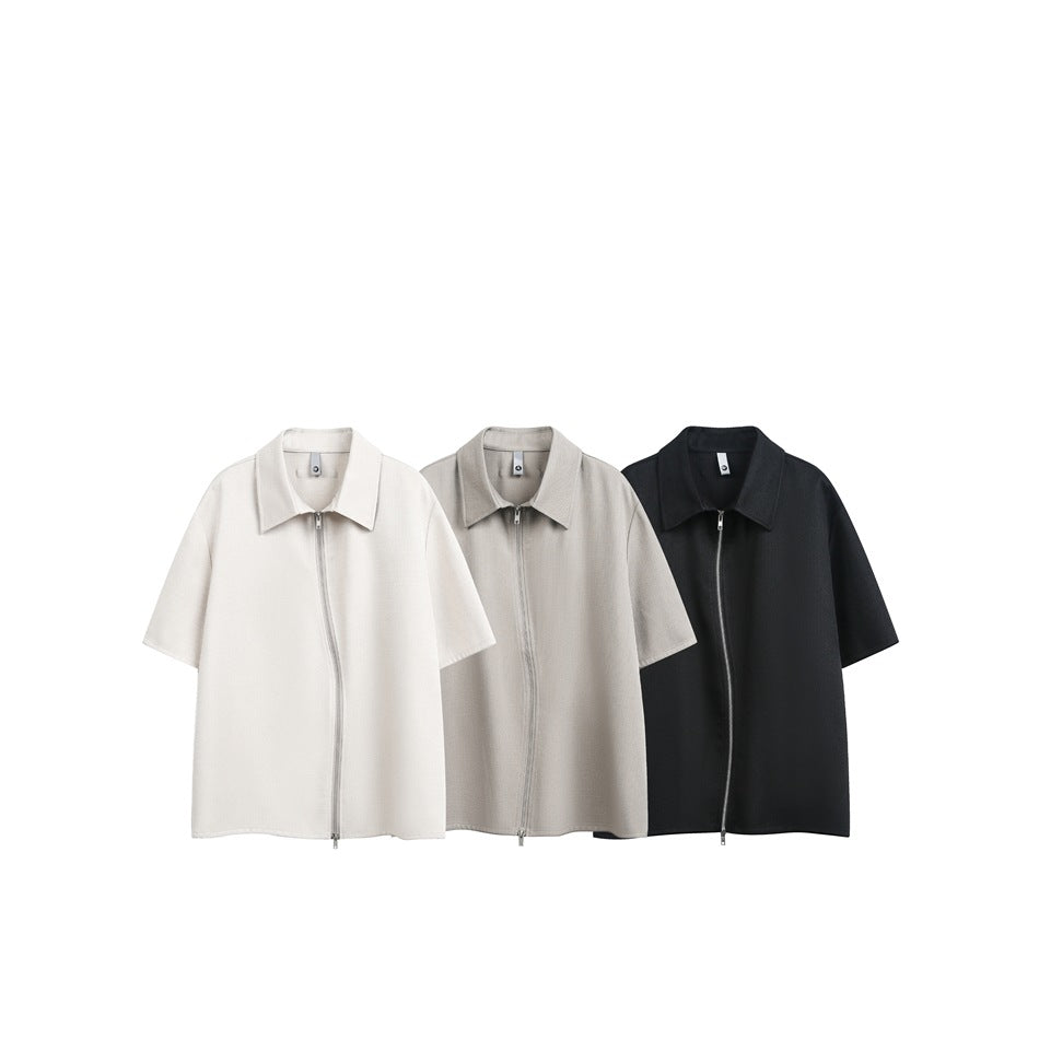 Three short-sleeve collared zip-front shirts displayed together in off-white, taupe, and black.