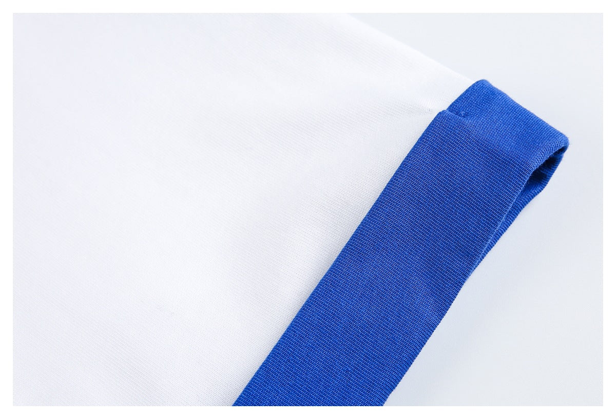 Close-up of a white shirt sleeve finished with a wide royal-blue cuff.
