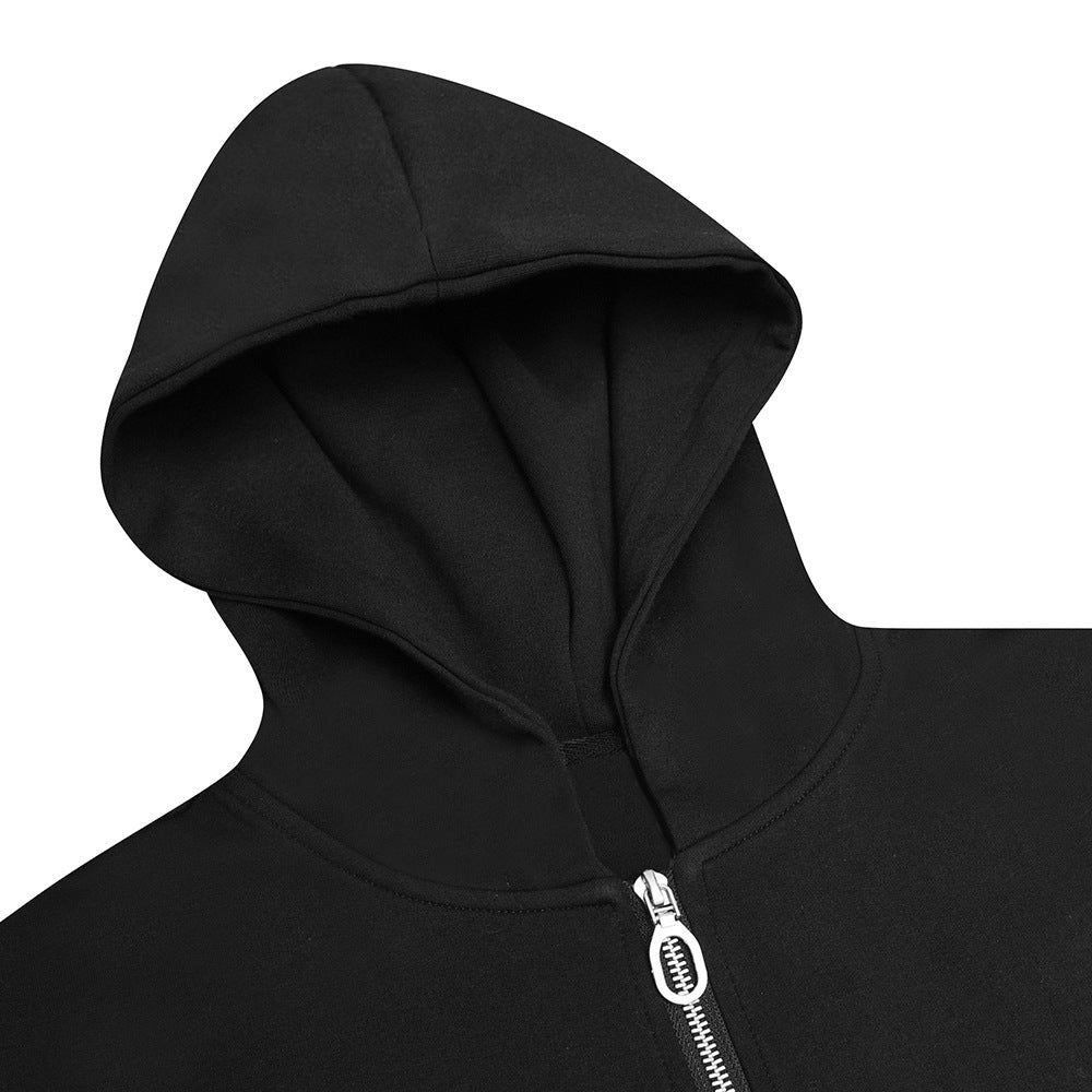 Close-up of a black hoodie showing its large hood, neckline, and silver front zipper.