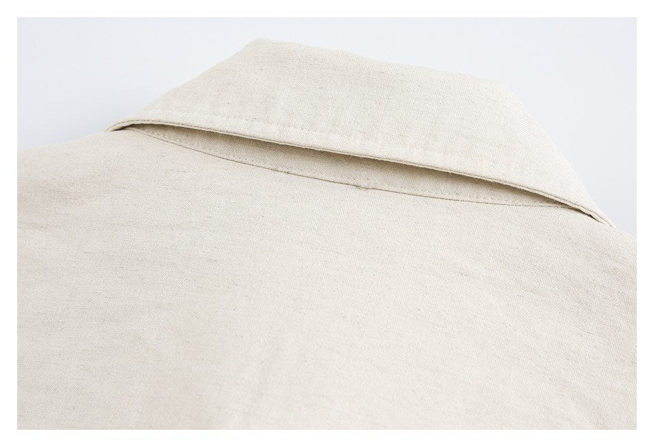 Close-up of a wide pointed collar on a light beige garment.