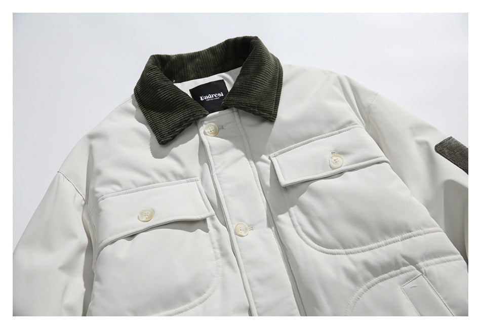 Close-up of the off-white jacket's dark corduroy collar, buttoned chest pockets, and front placket.