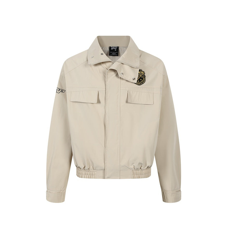 Khaki zip-front jacket with collar snaps, chest flap pockets, crest patch, elastic hem and tabbed cuffs, flat front view