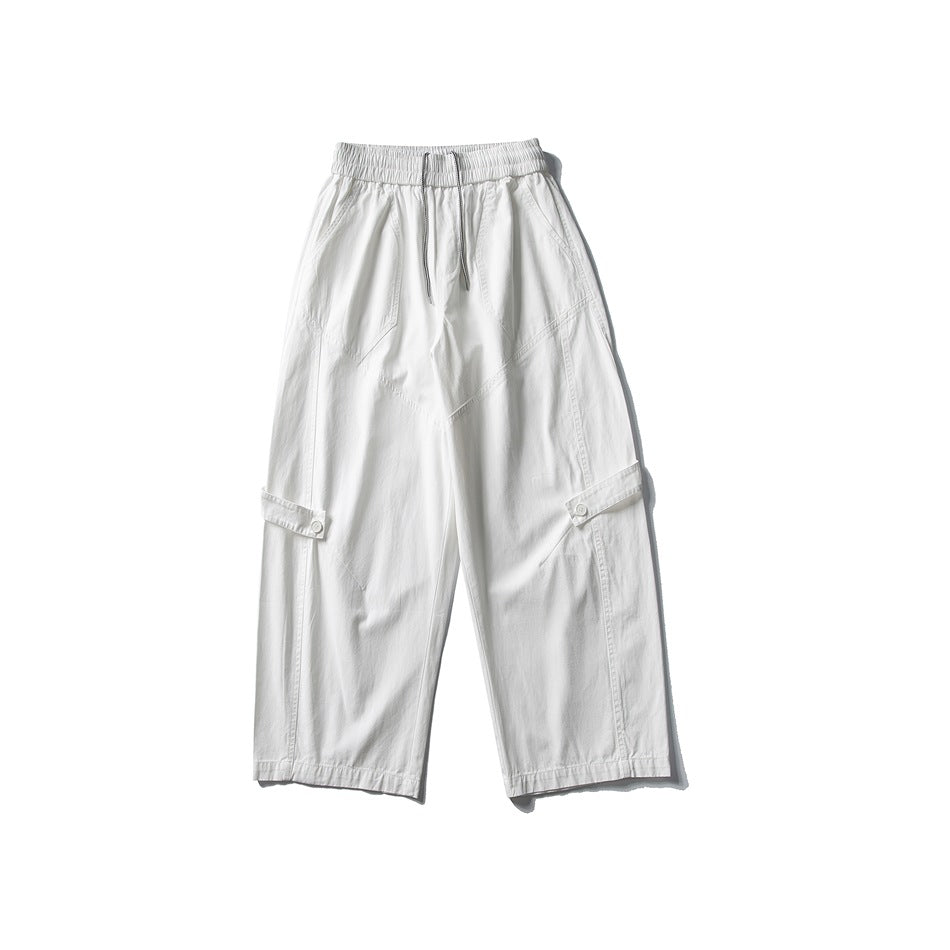 Off-white wide-leg pants flat lay with drawstring elastic waist, diagonal seams and buttoned leg tabs