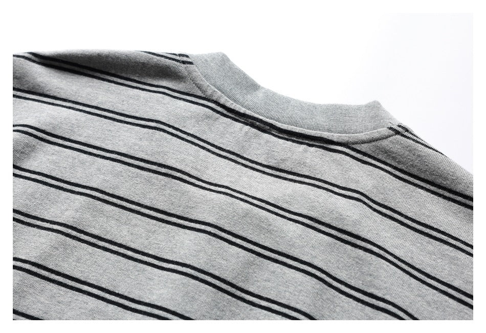 Close-up of the back neckline and upper body of a gray shirt with thin black stripes.