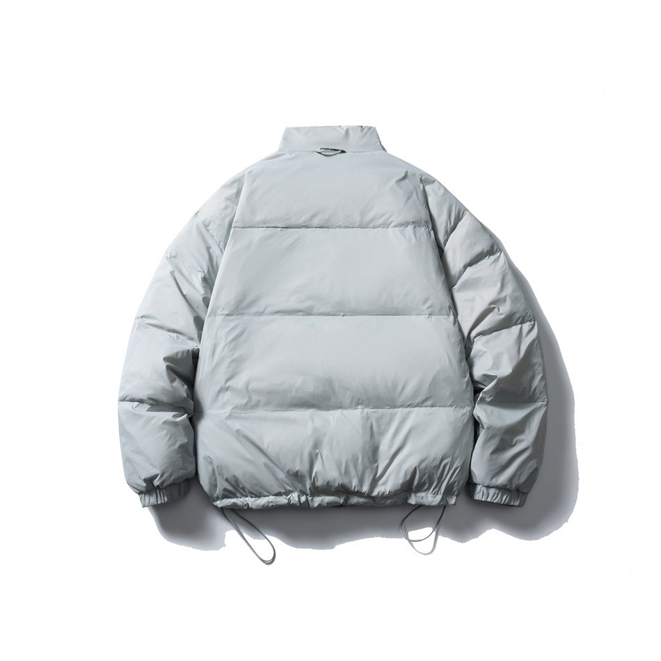 Back view of a light gray puffer jacket with horizontal quilting, a high collar, and adjustable hem cords.