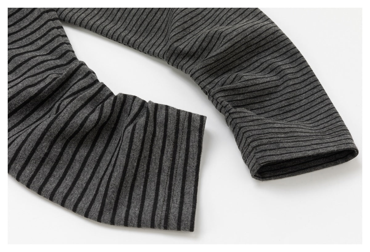 Close-up of the charcoal top's striped sleeves, showing a wide cuff and a narrower sleeve opening.