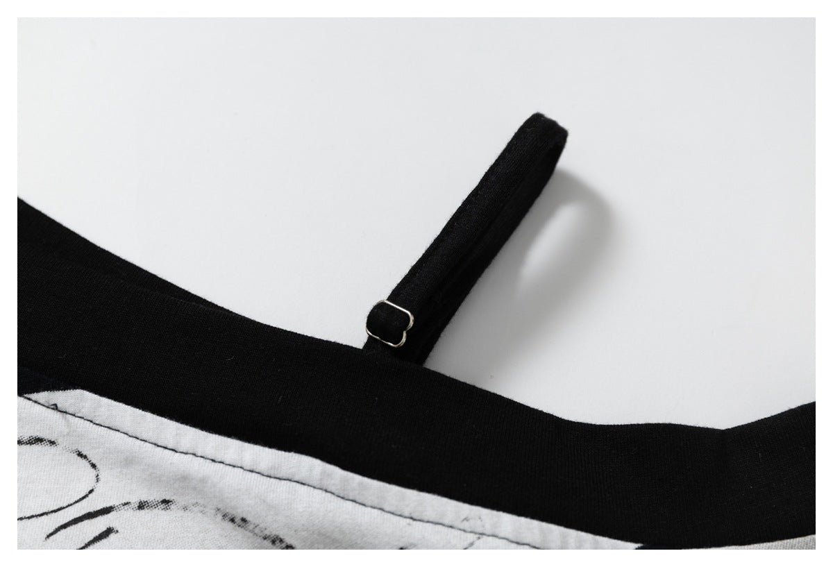 Close-up of the shirt’s narrow black shoulder strap and small metal adjuster beside the neckline.