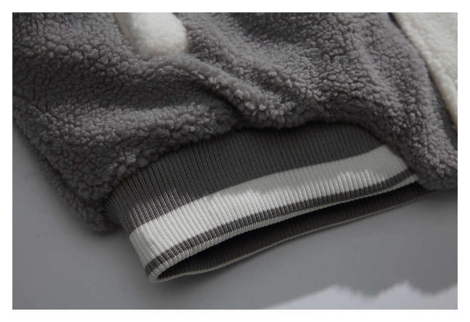 Close-up of the jacket's gray ribbed hem with a wide cream stripe.