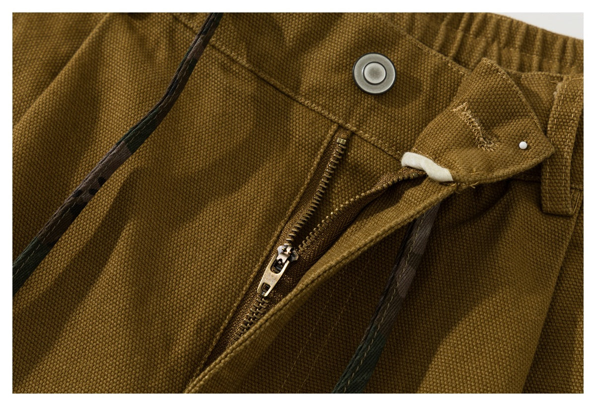 Close-up of the shorts' front zipper, snap closure, waistband, and drawstring.