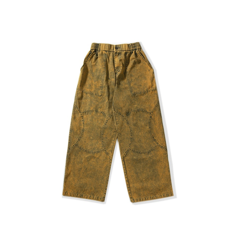 Flat-lay front of yellow-ochre washed wide-leg pants with elastic waist and circular knee stitching