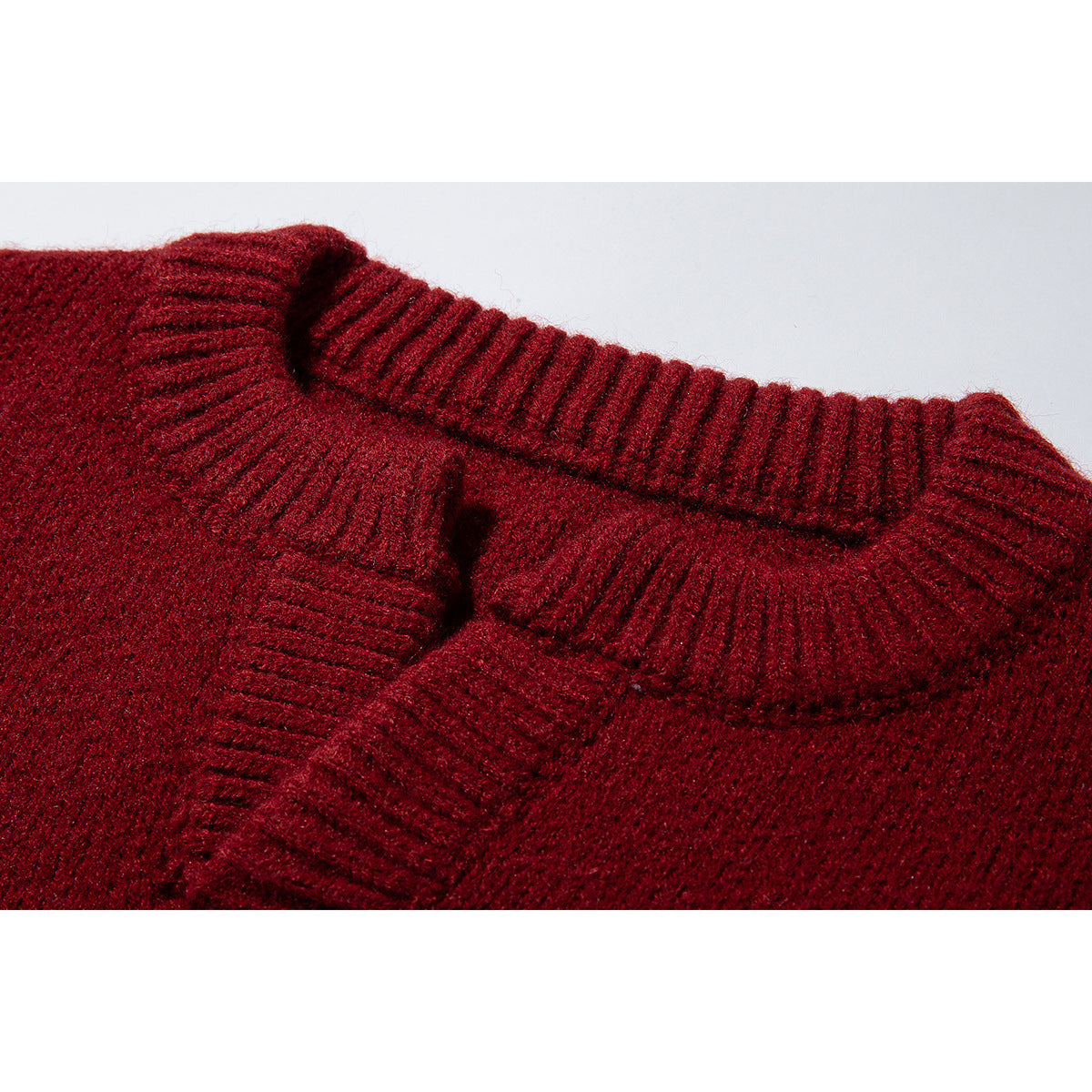 Close-up of a burgundy sweater's thick ribbed collar and neckline.