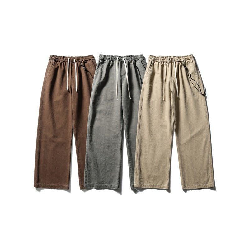 Three pairs of wide-leg drawstring trousers shown flat in brown, gray, and beige.