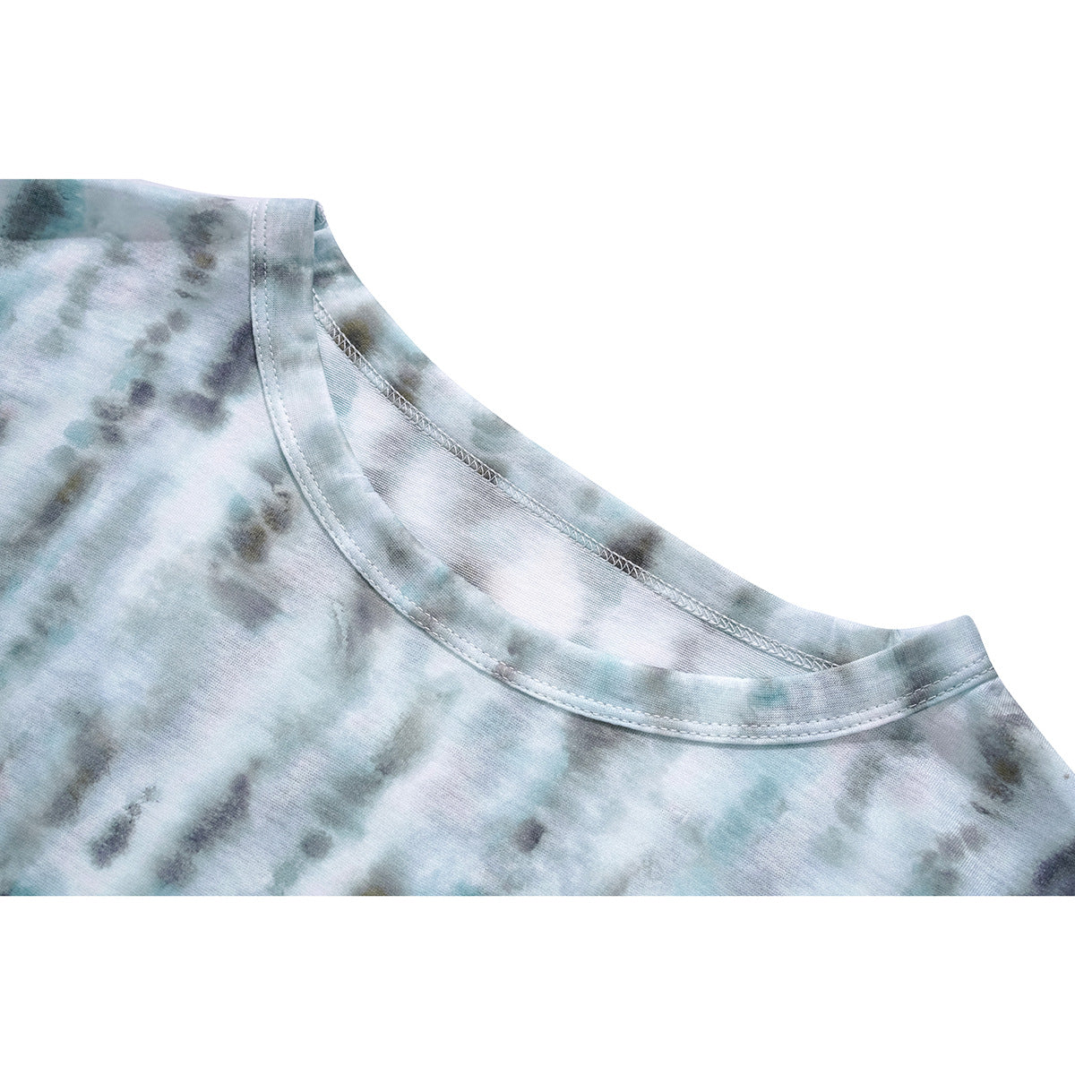 Close-up of a wide crew neckline and shoulder seam on a pale blue-gray tie-dye top.