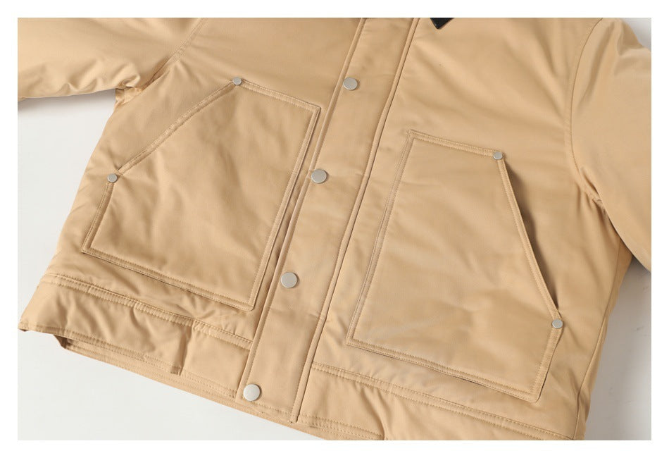 Tan jacket front detail showing two large patch pockets, silver snaps, and a button placket.