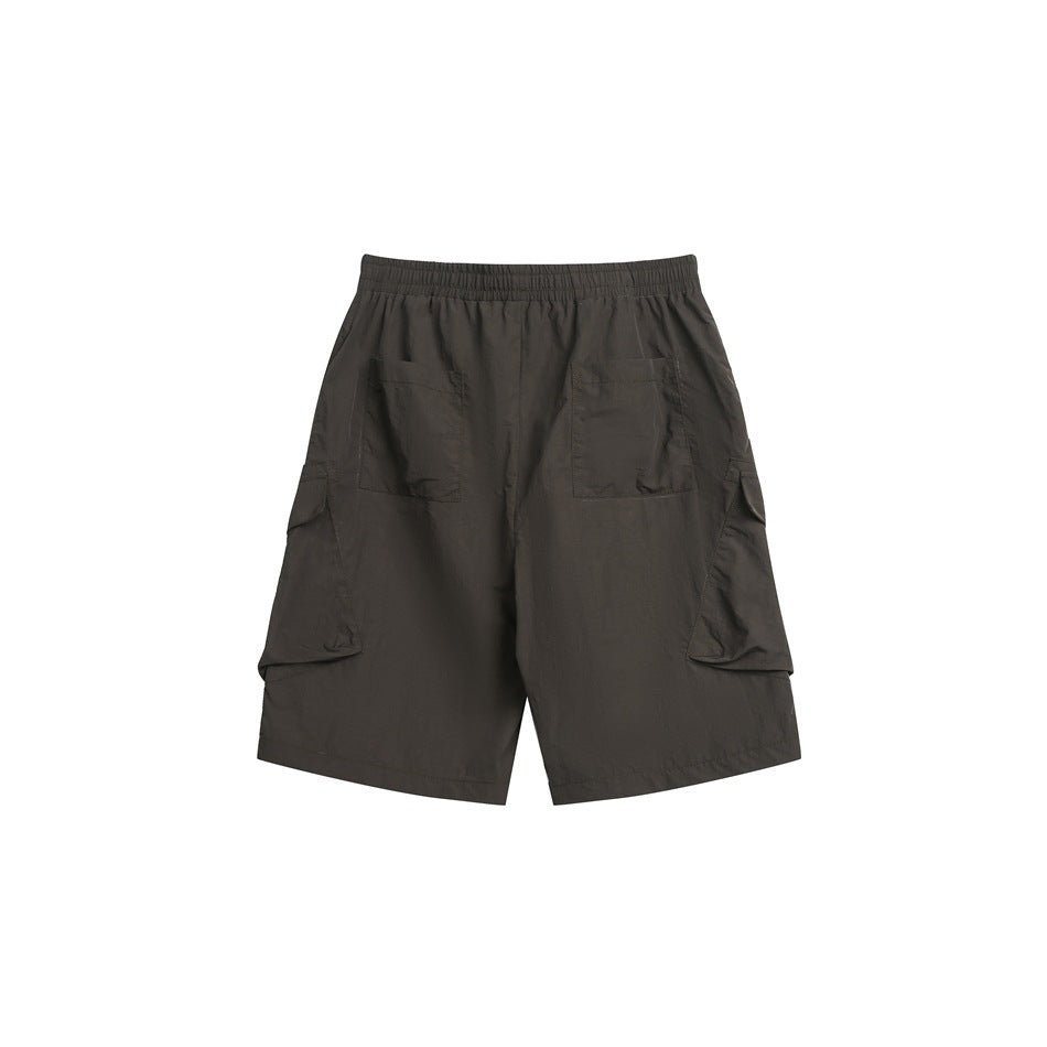 Rear view of dark charcoal cargo shorts with an elastic waist, two back patch pockets and large side cargo pockets.