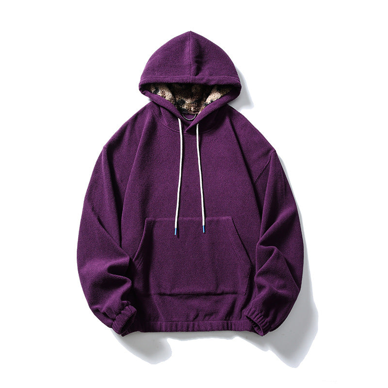 Grape purple fleece-like pullover hoodie with kangaroo pocket, white drawcords and patterned hood lining, flat lay