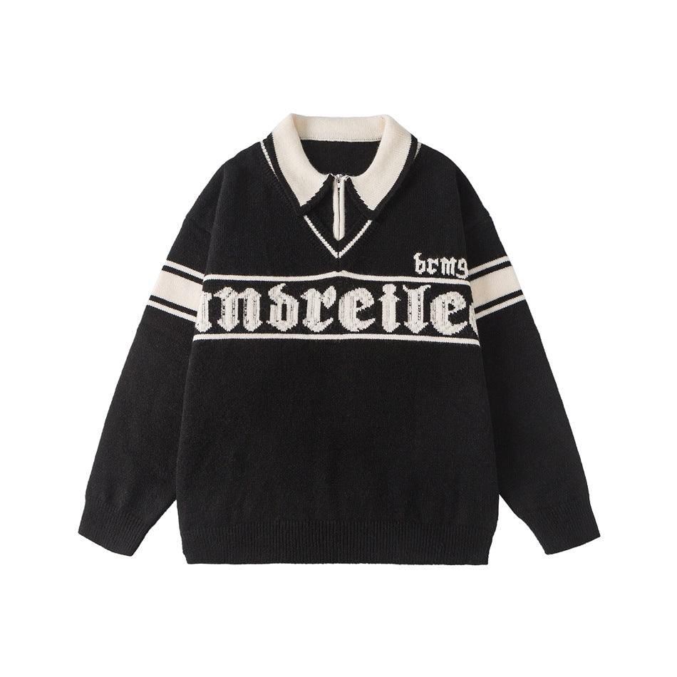 Black knit pullover with cream double collar, half zipper, gothic lettering band and striped sleeves, flat lay